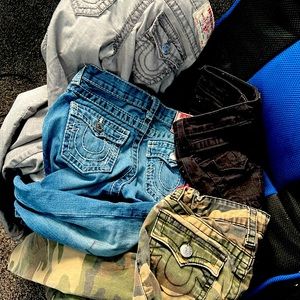 4 pair of true religion pants for boys. Blue pair has marker on front.